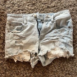American Eagle Distressed Light Denim Jeans with visible lace pockets
